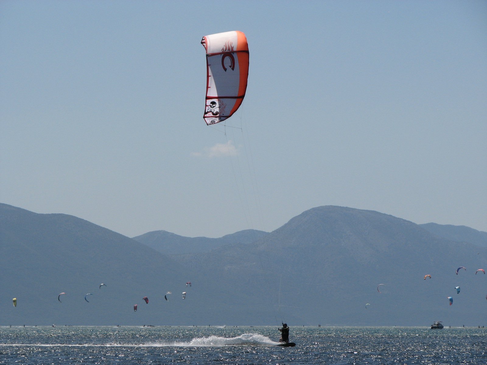 A kitesurfer riding beneath a large flying kite on the Croatian Adriatic