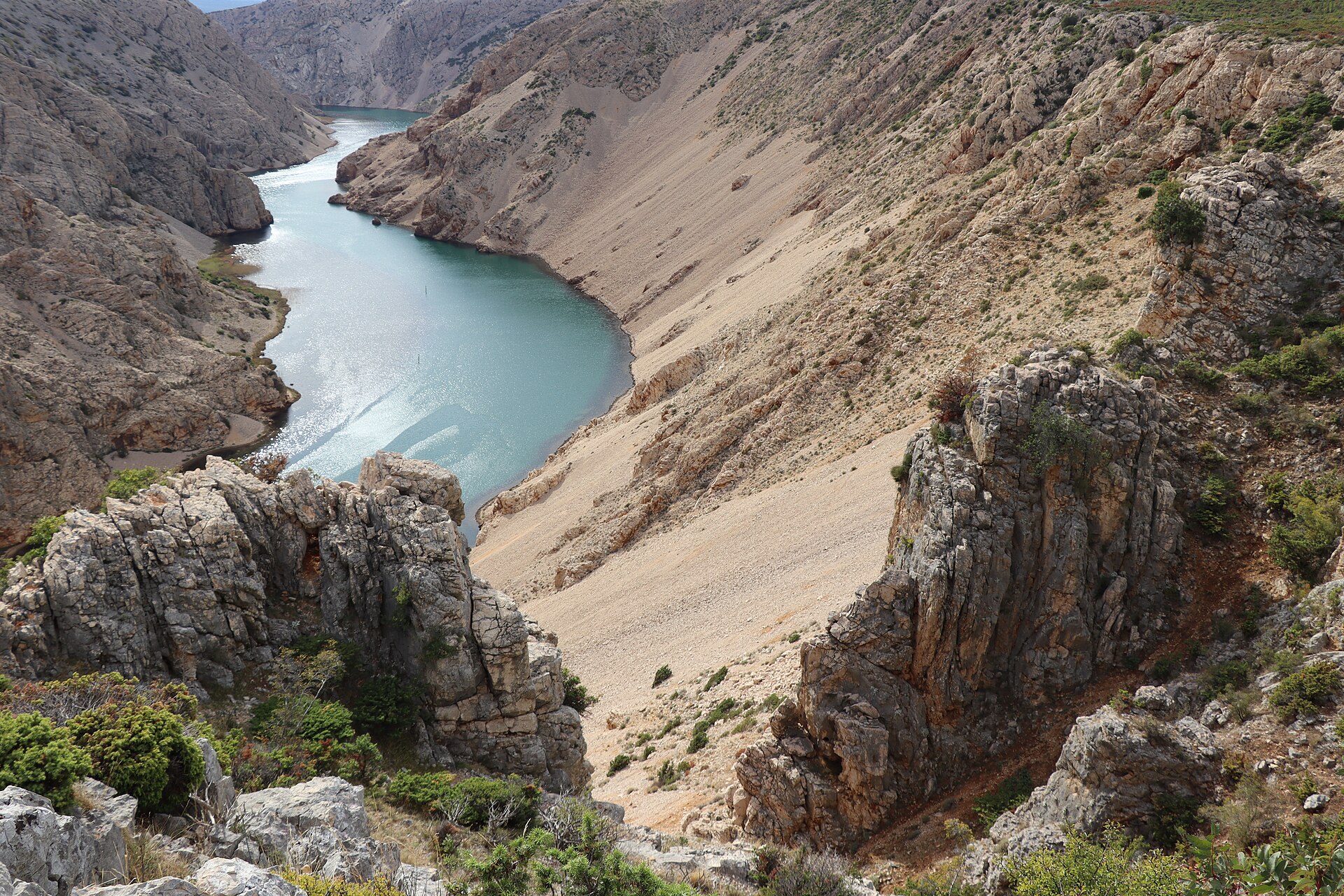 The turquoise Zrmanja River winding between limestone canyon walls in northern Dalmatia