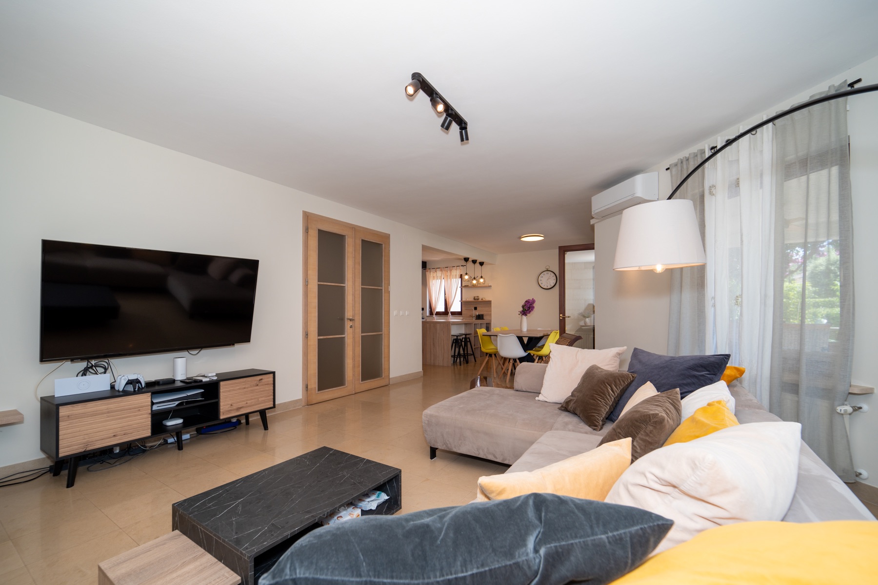 Villa Lostura’s relaxed living room with a generous sofa and warm evening light
