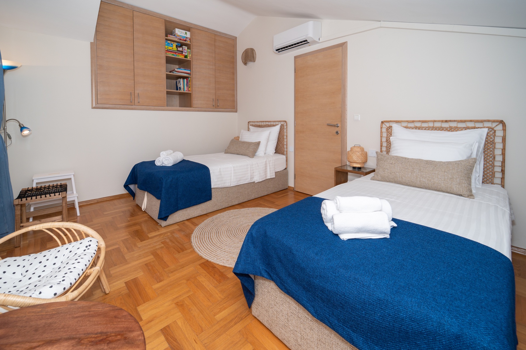 Twin bedroom with two single beds and blue textiles